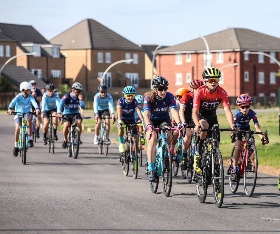 Race group riding in a bunch down the track.